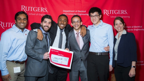 A group of male students with their female academic advisor pose with their first place certificate.