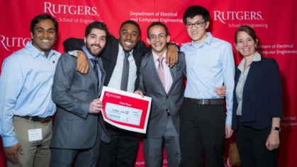 Group of five students holding their first place award along with their female advisor.