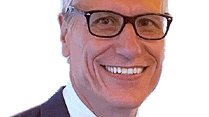 Headshot of male with short grey hair wearing eyeglasses.