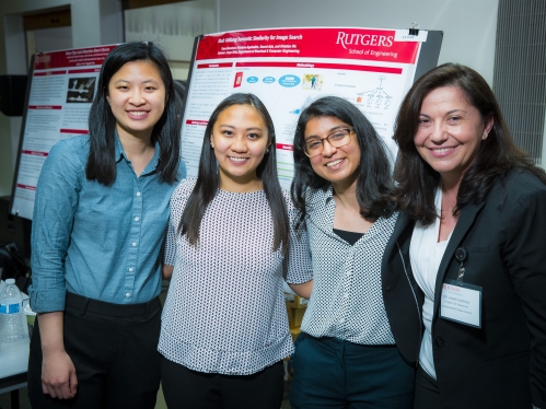 Three female students pose with their female advisor.